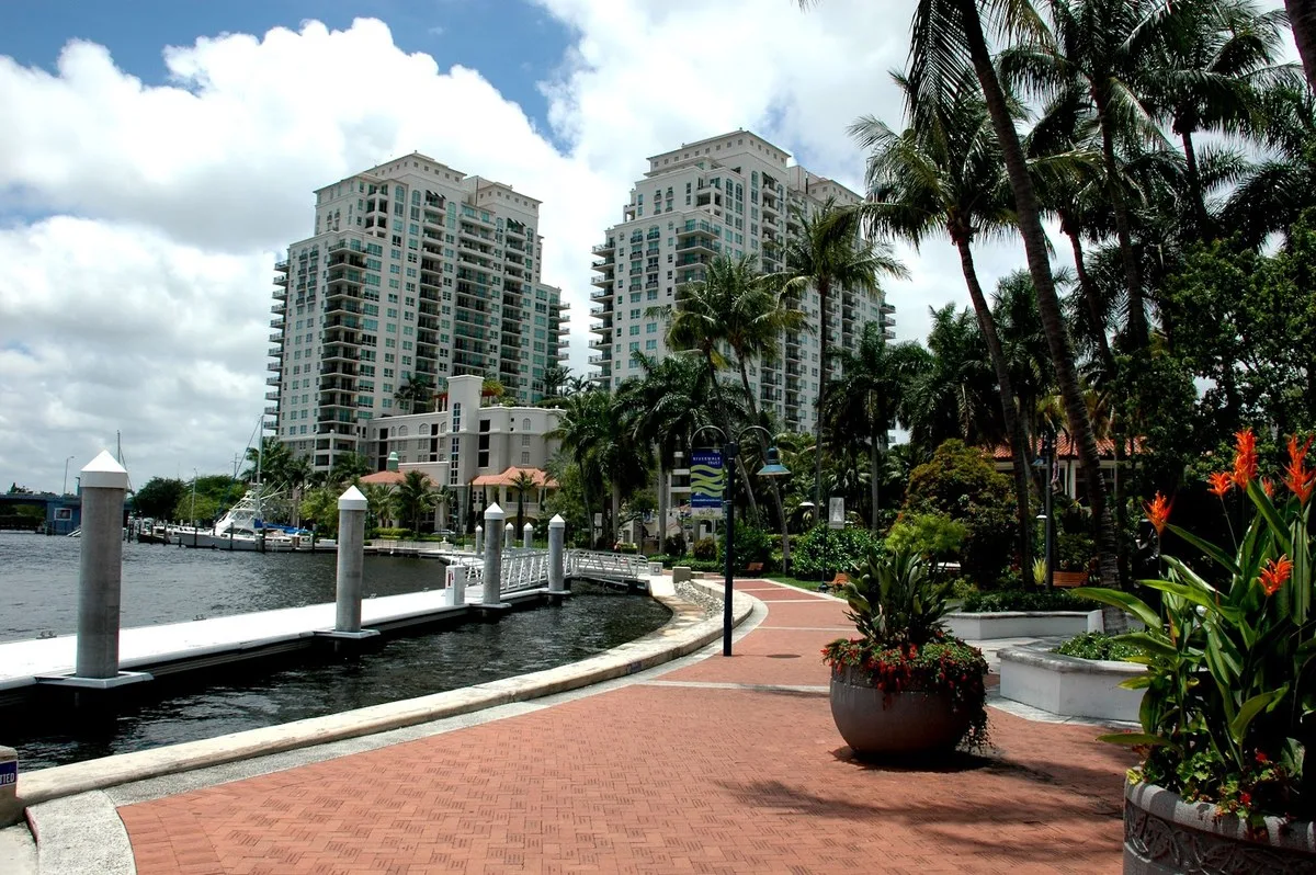 Fort Lauderdale Riverwalk promenade with marina yachts along the New River